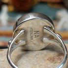 Navajo sterling silver ring by N.A. featuring a round red spiny oyster shell cabochon with natural color variations in a smooth silver bezel; artisan and Sterling Silver stamp.
