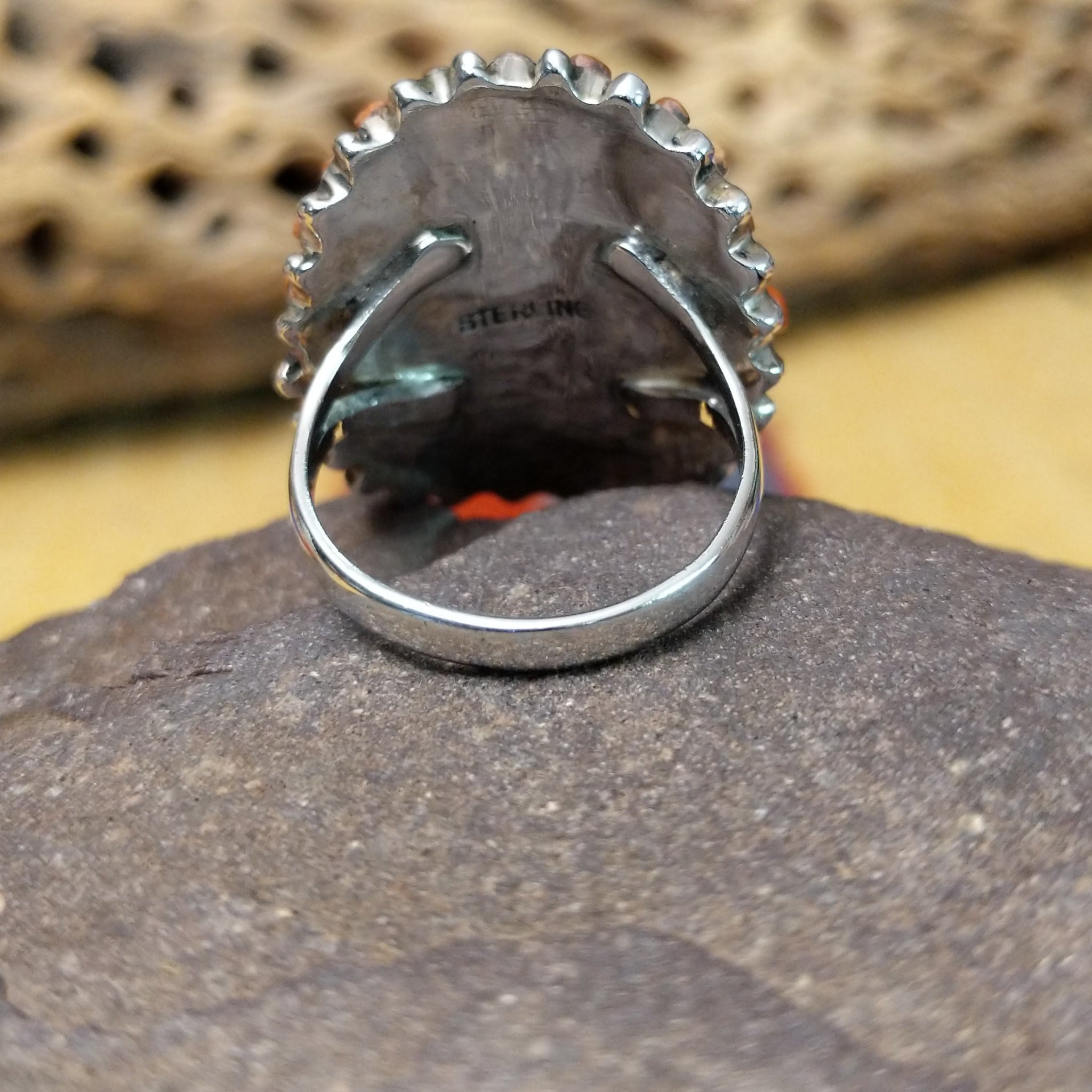 Navajo red spiny oyster shell concho ring, featuring a vibrant red spiny oyster shell set in a handcrafted sterling silver concho-style band with traditional Southwestern details.  Underside view.