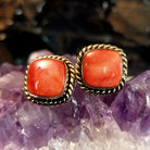 Square red spiny oyster shell earrings with twisted rope silver and gold borders.
