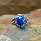 Sterling silver ring with lapis set in the round bezel, framed by twisted rope and dotted accents on the band.