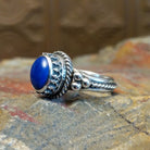 Sterling silver ring with lapis set in the round bezel, framed by twisted rope and dotted accents on the band.