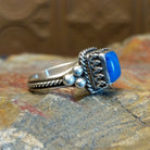 Sterling silver ring with lapis set in the square bezel, framed by twisted rope and dotted accents.