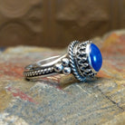 Sterling silver ring with lapis set in the round bezel, framed by twisted rope and dotted accents on the band.