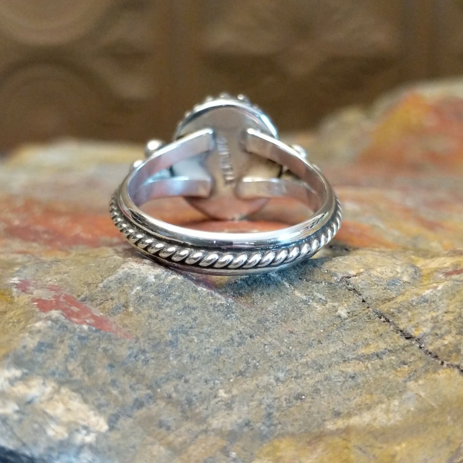 Sterling silver ring with lapis set in the round bezel, framed by twisted rope and dotted accents on the band.