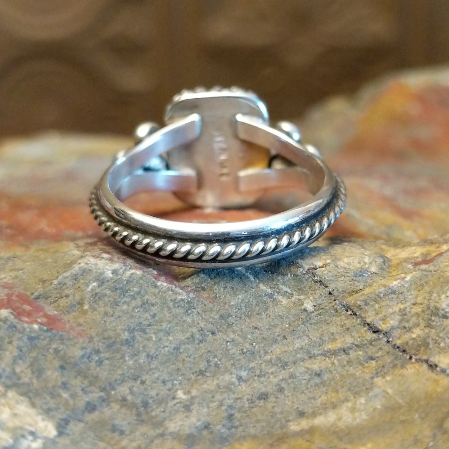 Sterling silver ring with lapis set in the square bezel, framed by twisted rope and dotted accents.