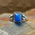 Sterling silver ring with lapis set in the square bezel, framed by twisted rope and dotted accents.