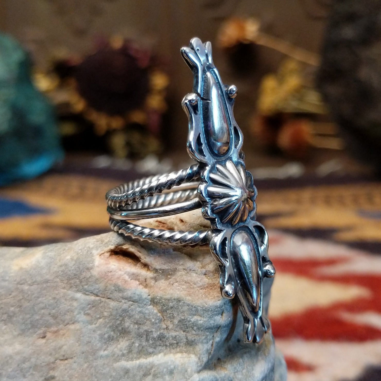 Handcrafted Navajo sterling silver ring featuring intricate silver detailing and traditional Southwestern craftsmanship in a bold regal design.  Side view.
