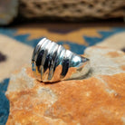 Handcrafted sterling silver Navajo ridged ring, featuring a polished domed design with bold vertical ridges; side view.