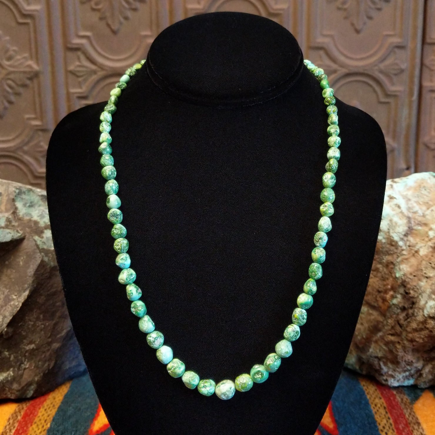 Rough cut Sonoran Gold turquoise beaded along the sterling silver chain of the necklace.