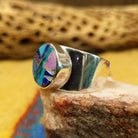 Navajo round multistone inlay ring, featuring a circular arrangement of natural stones set in a handcrafted sterling silver band with traditional Southwestern-inspired craftsmanship.  Side view.