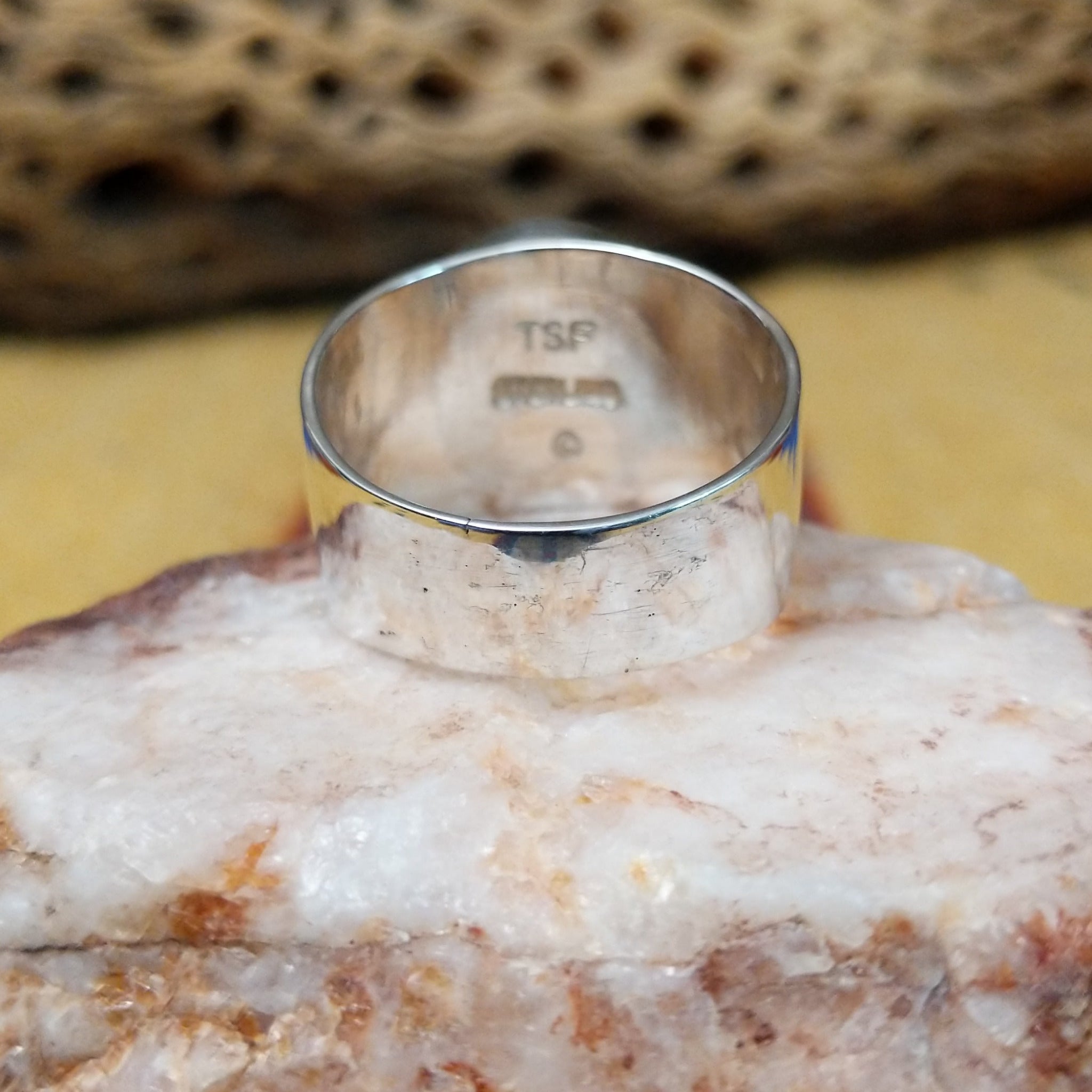Navajo round multistone inlay ring, featuring a circular arrangement of natural stones set in a handcrafted sterling silver band with traditional Southwestern-inspired craftsmanship.  Underside view.