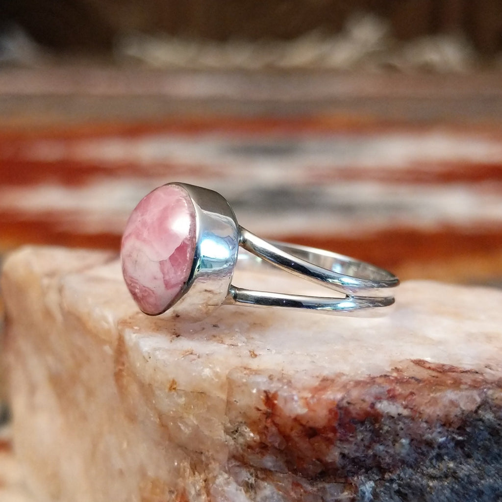 Round rhodochrosite set in sterling silver with polished layered band of the ring.
