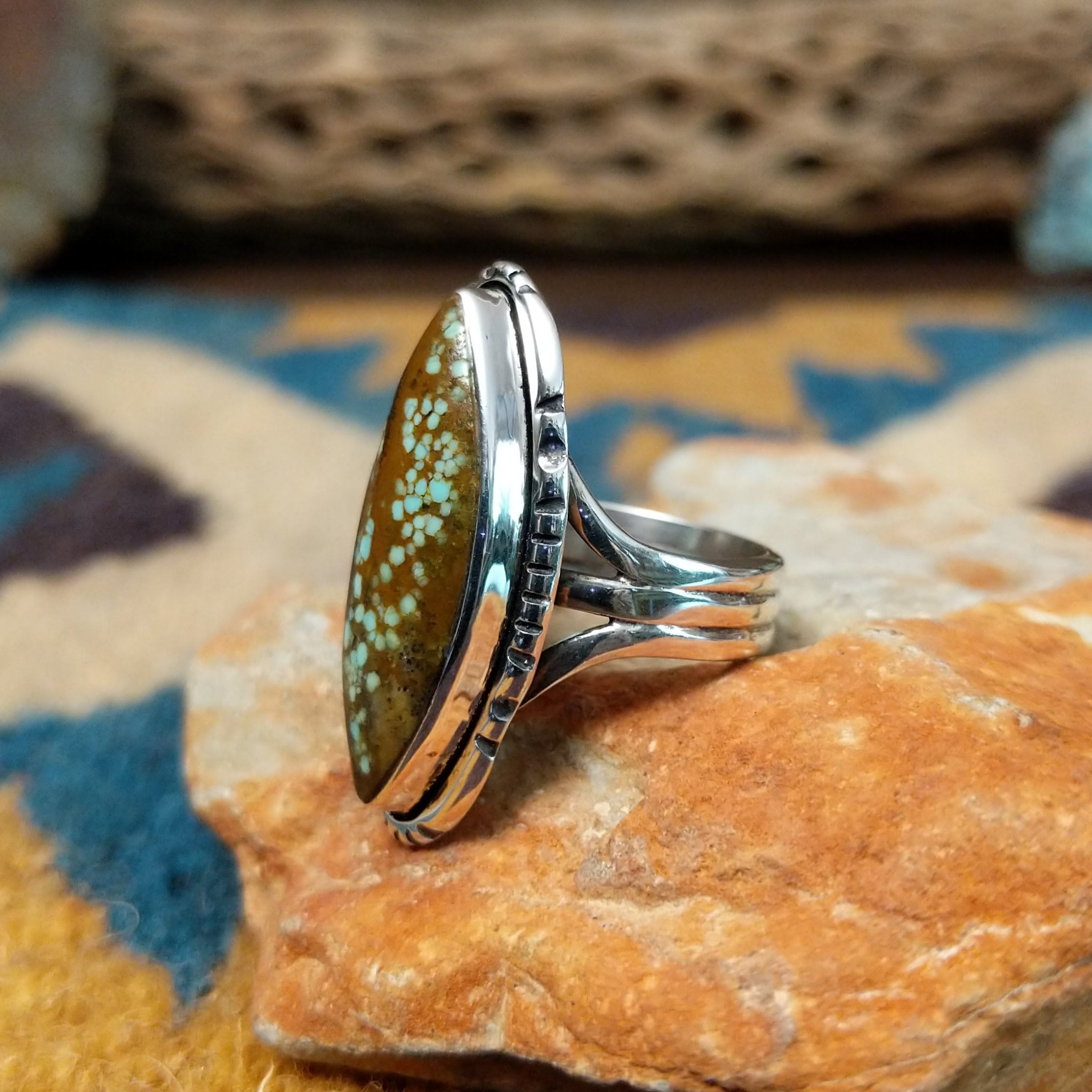 Handcrafted sterling silver Navajo Royston turquoise navette ring by K., featuring a natural Royston turquoise gemstone with brown matrix in a classic navette setting; side view.