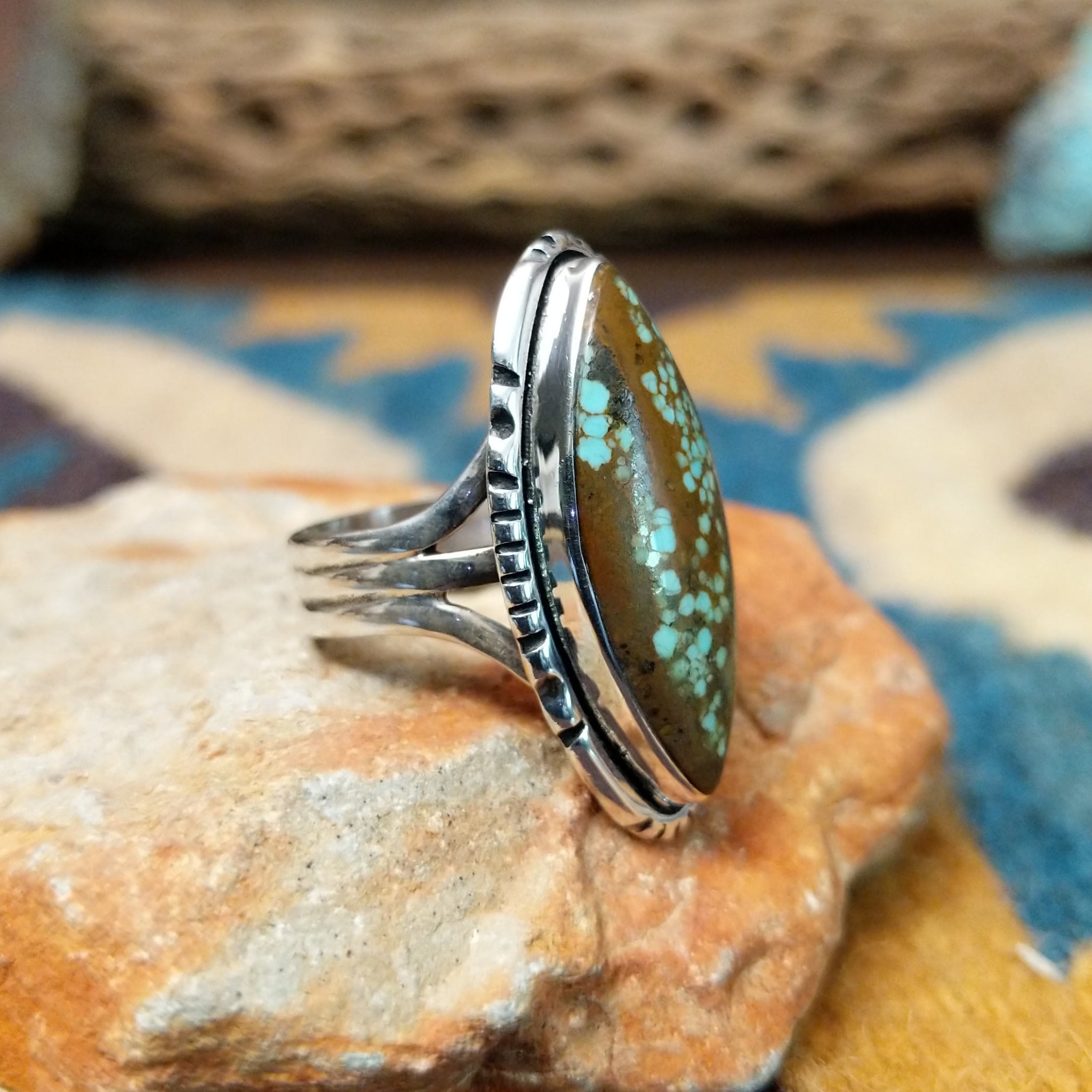 Handcrafted sterling silver Navajo Royston turquoise navette ring by K., featuring a natural Royston turquoise gemstone with brown matrix in a classic navette setting; side view.