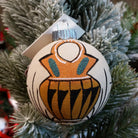 Sand painted ornament with traditional wedding vase motif.