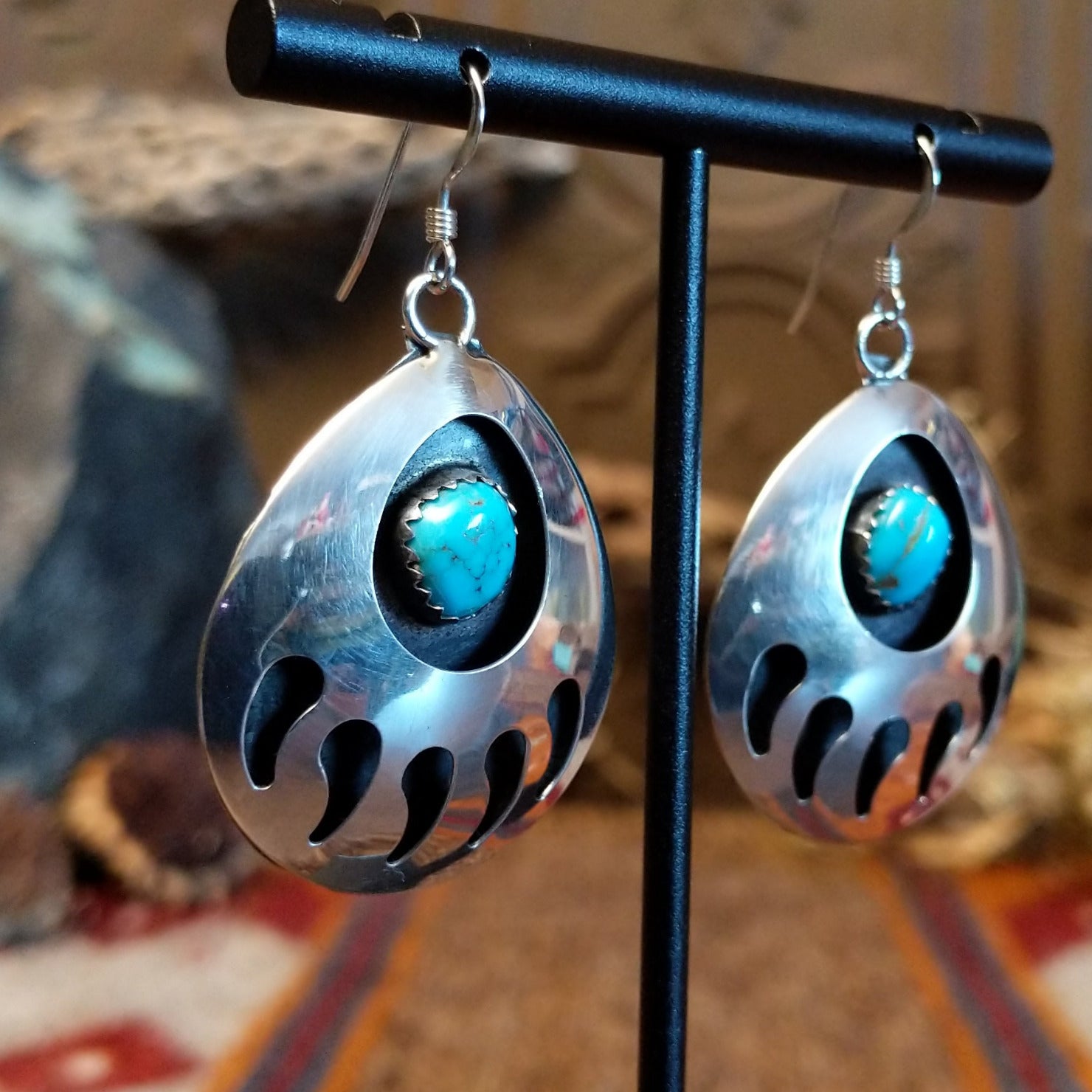 Sterling silver shadowbox bear paw earrings with turquoise set in notched bezels.
