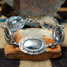 Navajo sterling silver concho bracelet with hand-stamped concho designs and traditional Southwestern detailing.