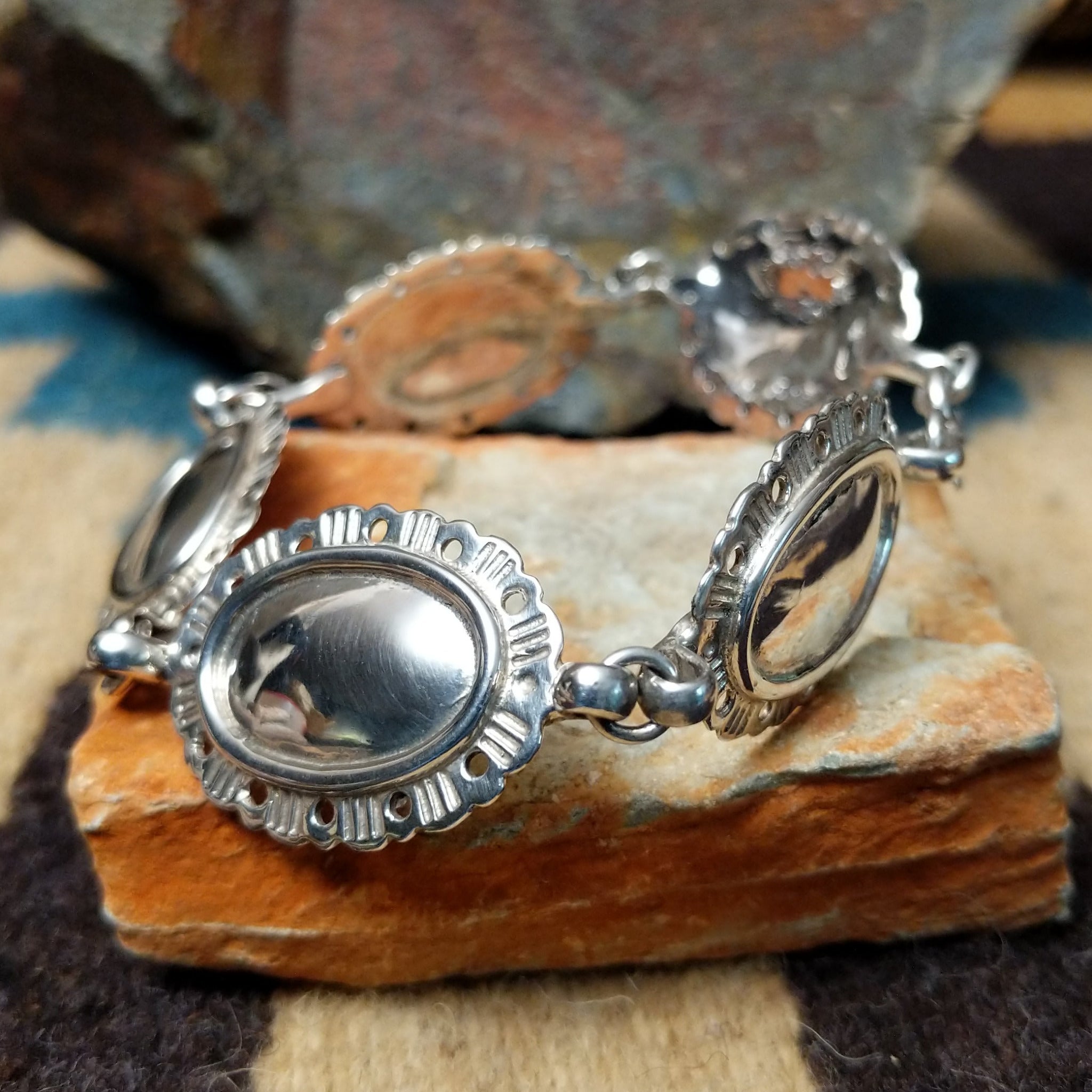 Navajo sterling silver concho bracelet with hand-stamped concho designs and traditional Southwestern detailing.