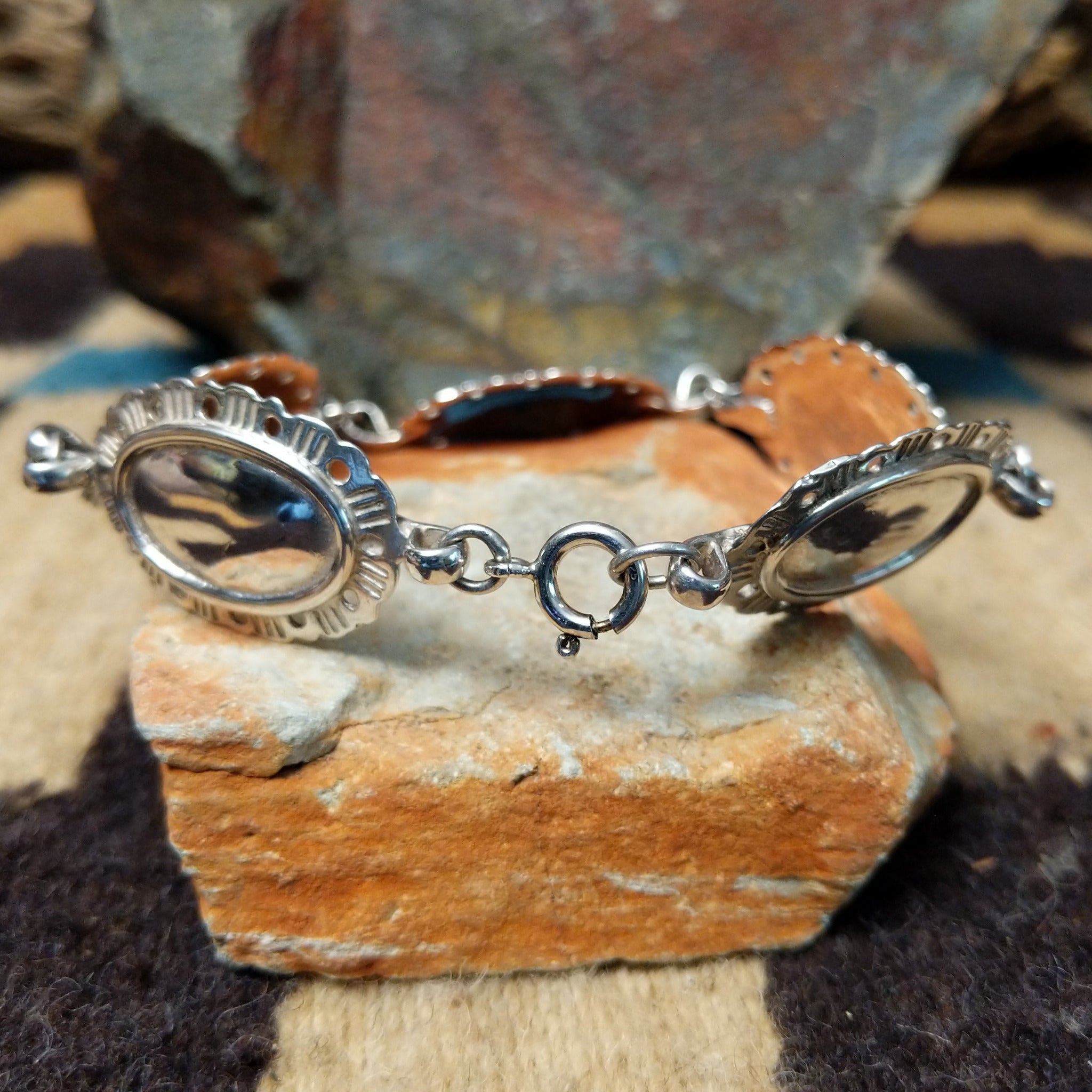 Navajo sterling silver concho bracelet with hand-stamped concho designs and traditional Southwestern detailing.