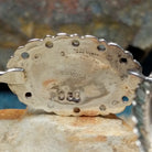 Navajo sterling silver concho bracelet with hand-stamped concho designs and traditional Southwestern detailing; artisan and Sterling Silver stamp.