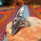 Navajo silver concho ring with elongated oval face and radiating stamped design.