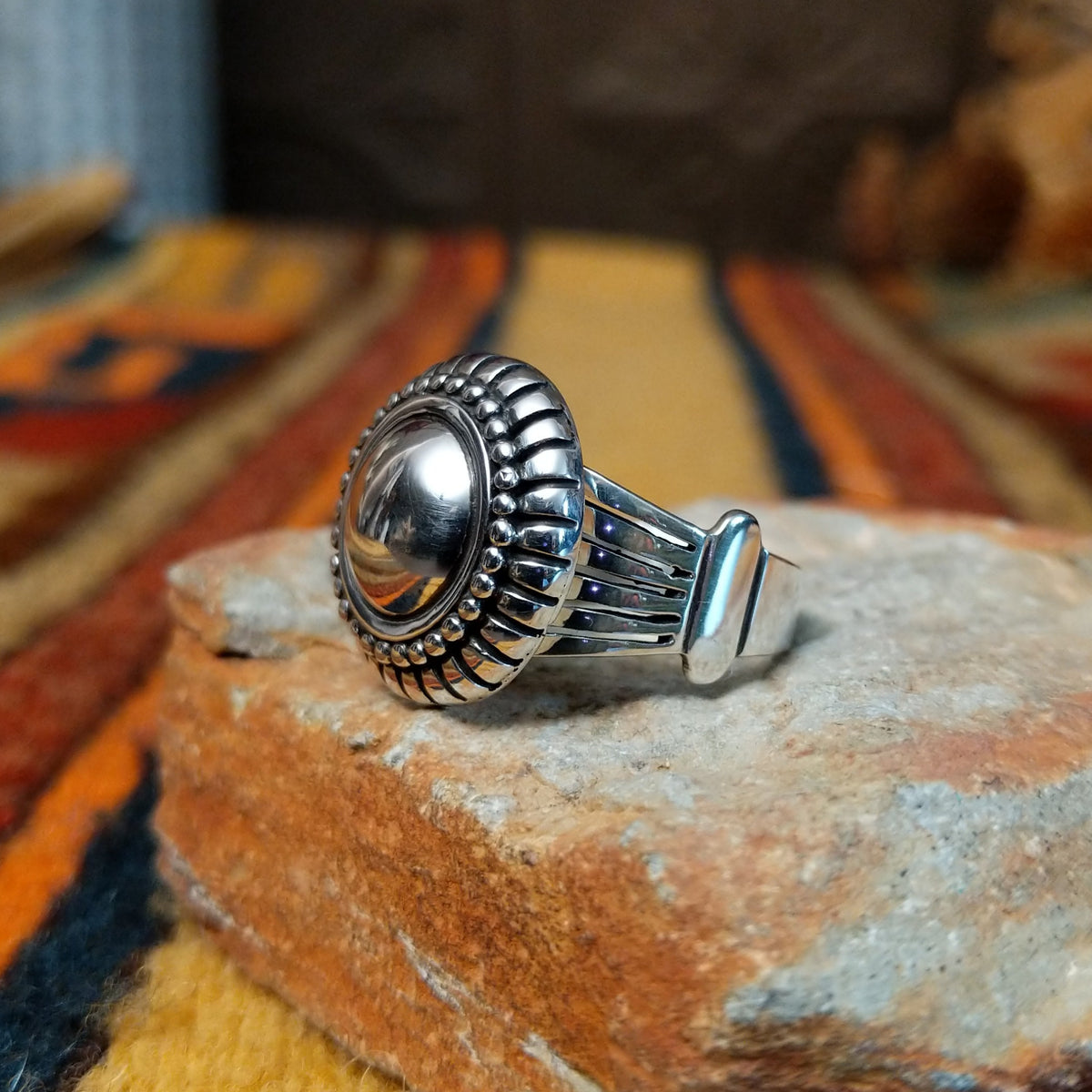 Authentic Navajo sterling silver dome ring with polished curved design. Features elegant silhouette suitable for everyday wear or special occasions. Size 8.5, measures approximately 0.75" L x 0.875" W, weighs approximately 0.2 oz; side view.