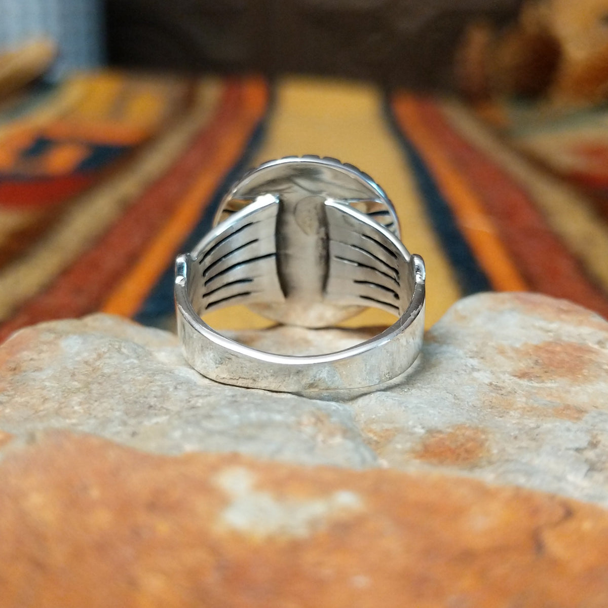 Authentic Navajo sterling silver dome ring with polished curved design. Features elegant silhouette suitable for everyday wear or special occasions. Size 8.5, measures approximately 0.75" L x 0.875" W, weighs approximately 0.2 oz; underside view.