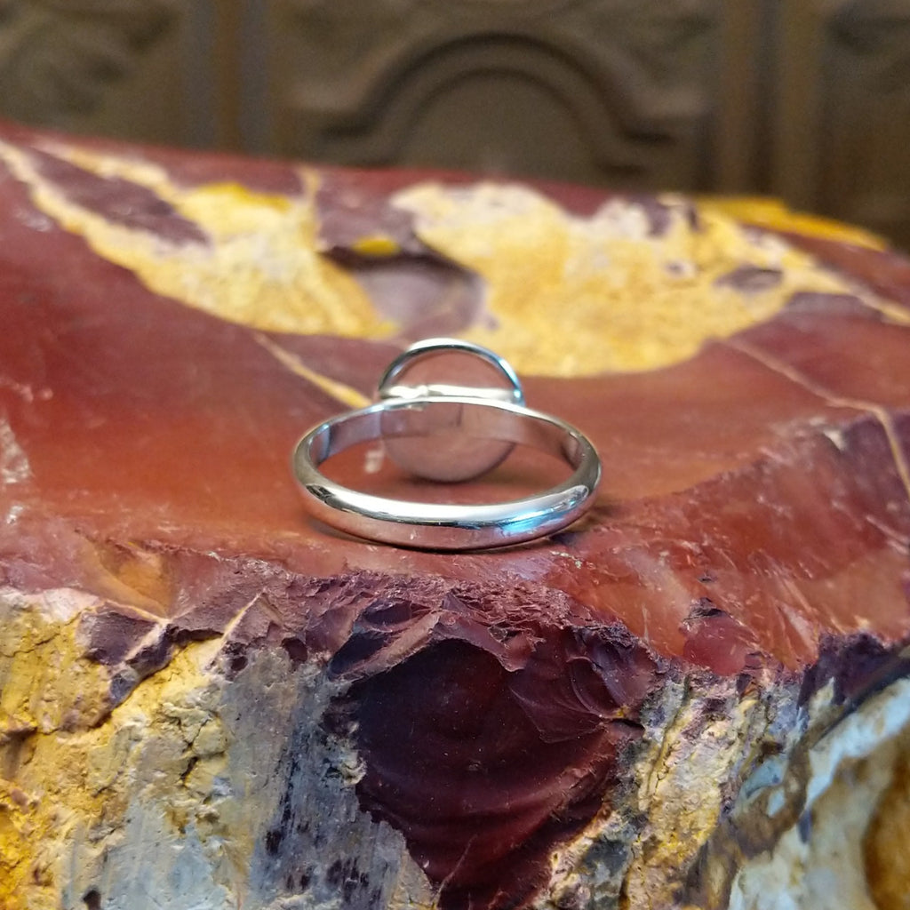 Sterling silver ring with dome centerpiece set in a shadowbox setting.