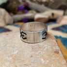 Sterling silver Navajo ring by L.G. with a brushed finish and hand-cut geometric design.