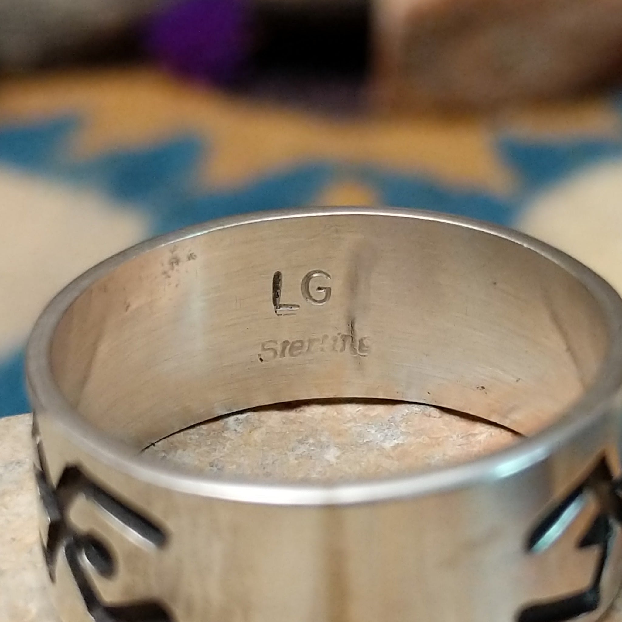 Sterling silver Navajo ring by L.G. with a brushed finish and hand-cut geometric design; artisan and Sterling Silver stamp.