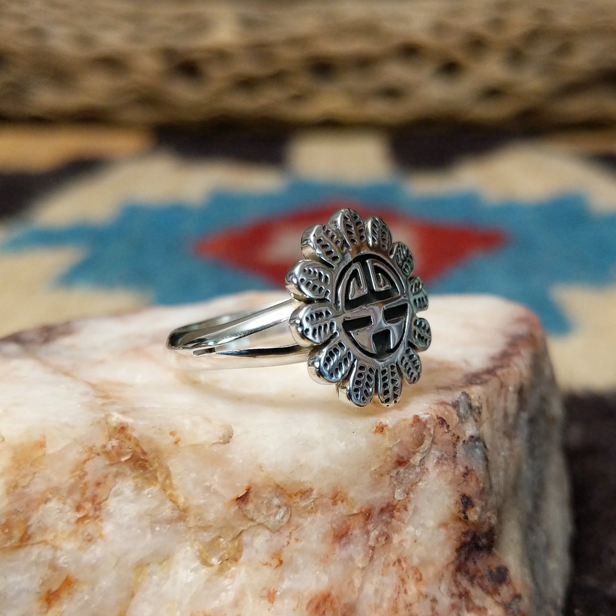 Navajo silver Sunface ring, featuring a handcrafted sterling silver Sunface design with intricate detailing and traditional Southwestern craftsmanship.  Side view.