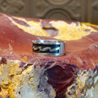 Sterling silver ring with zigzag patterns on its surface.