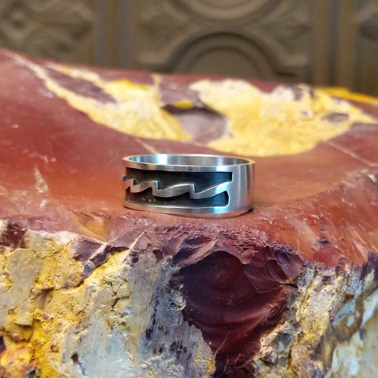 Sterling silver ring with zigzag patterns on its surface.