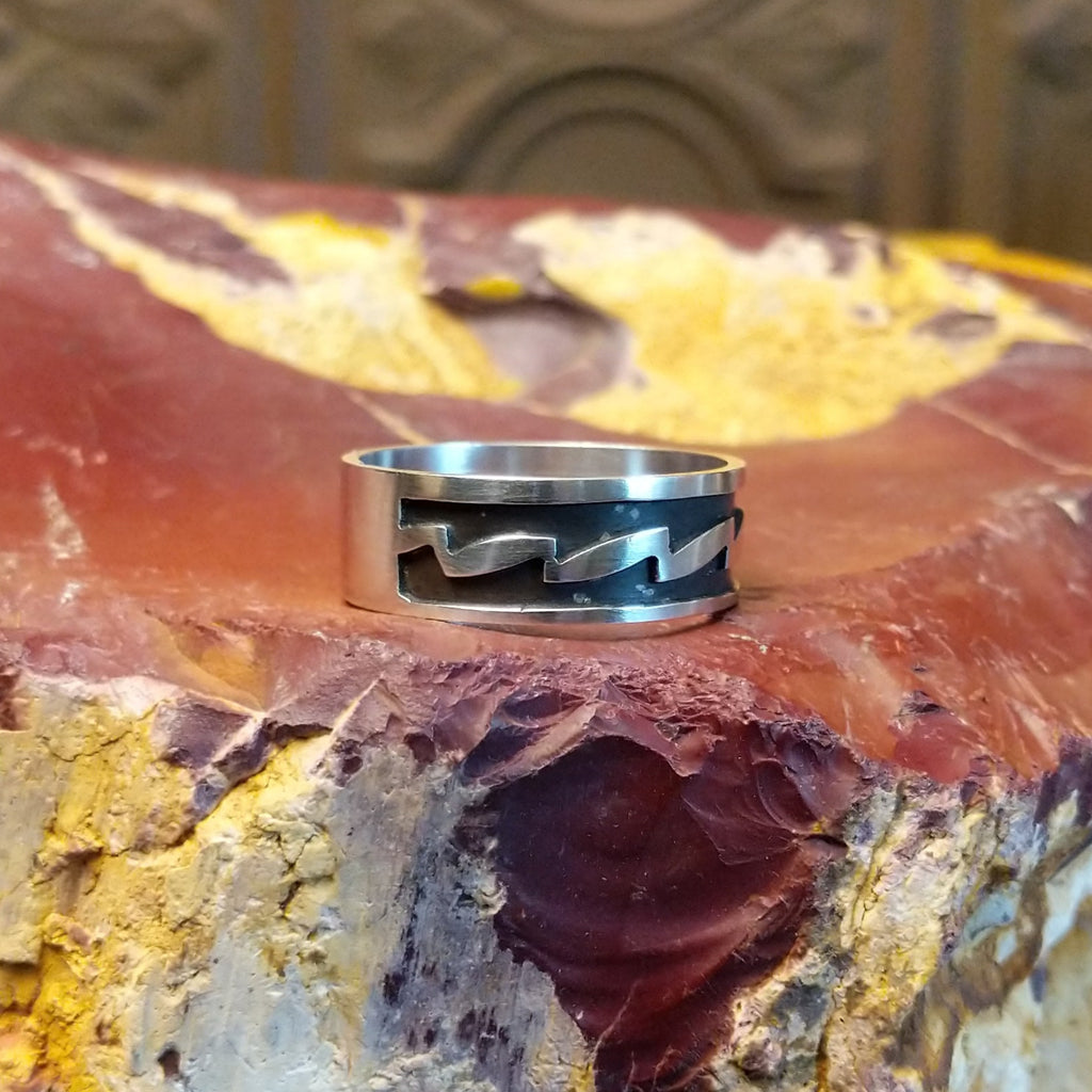 Sterling silver ring with zigzag patterns on its surface.