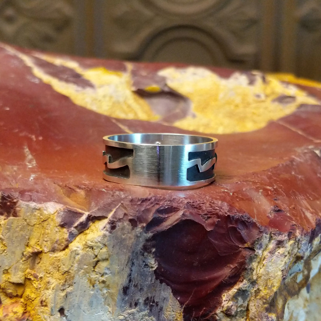 Sterling silver ring with zigzag patterns on its surface.