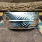 Navajo smooth silver feather cuff by A.D., featuring a handcrafted sterling silver feather design with polished contours and traditional Southwestern craftsmanship.