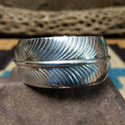 Navajo smooth silver feather cuff by A.D., featuring a handcrafted sterling silver feather design with polished contours and traditional Southwestern craftsmanship.
