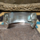 Navajo smooth silver feather cuff by A.D., featuring a handcrafted sterling silver feather design with polished contours and traditional Southwestern craftsmanship.  Underside view.