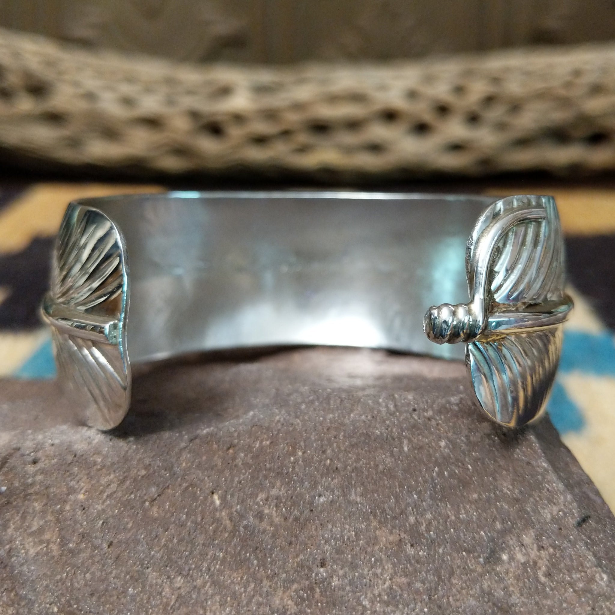 Navajo smooth silver feather cuff by A.D., featuring a handcrafted sterling silver feather design with polished contours and traditional Southwestern craftsmanship.  Underside view.