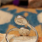 Handcrafted Navajo sterling silver bypass ring featuring two oval Sonoran Gold turquoise cabochons in smooth bezel settings, with vibrant blue and green natural turquoise on a polished open-band design; artisan and Sterling Silver stamp.