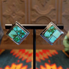 Sterling silver earrings with Sonoran Gold turquoise inlays, framed by the diamond settings.