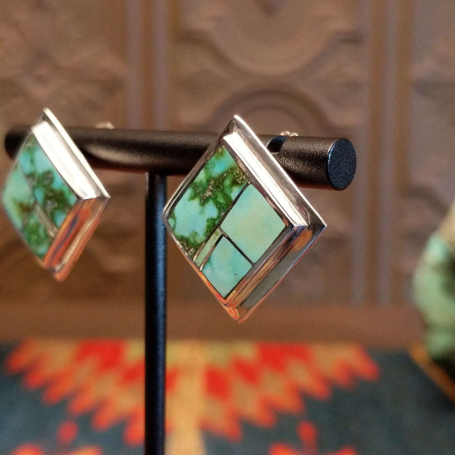 Sterling silver earrings with Sonoran Gold turquoise inlays, framed by the diamond settings.