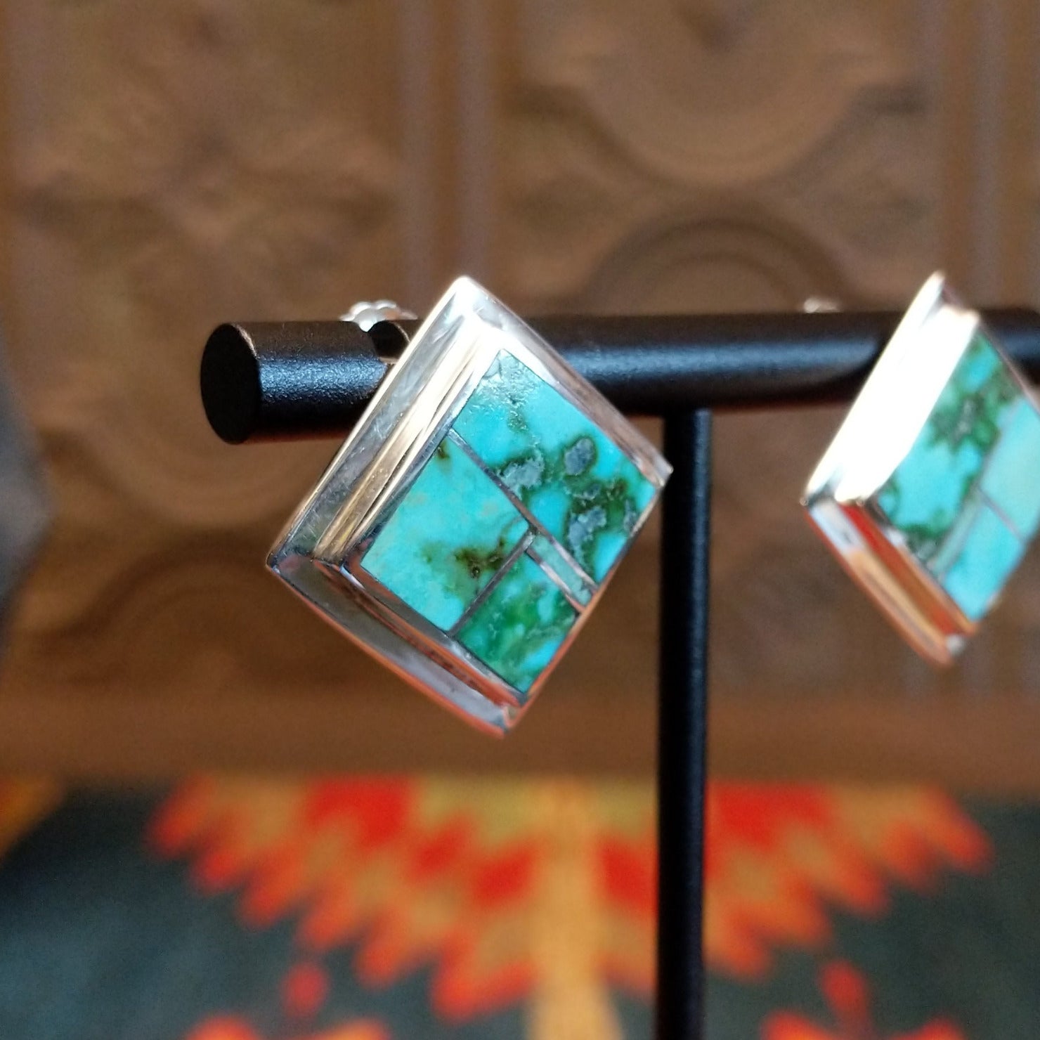 Sterling silver earrings with Sonoran Gold turquoise inlays, framed by the diamond settings.