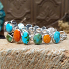Sterling silver bracelet with turquoise and orange spiny oyster shell set in multiple bezels.