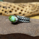 Navajo Sonoran Gold turquoise roped ring, featuring a blue and green Sonoran Gold turquoise stone surrounded by a twisted rope border in a handcrafted sterling silver band.  Side view.