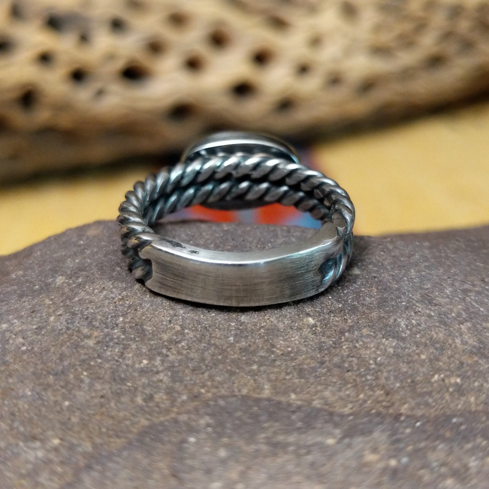 Navajo Sonoran Gold turquoise roped ring, featuring a blue and green Sonoran Gold turquoise stone surrounded by a twisted rope border in a handcrafted sterling silver band.  Underside view.