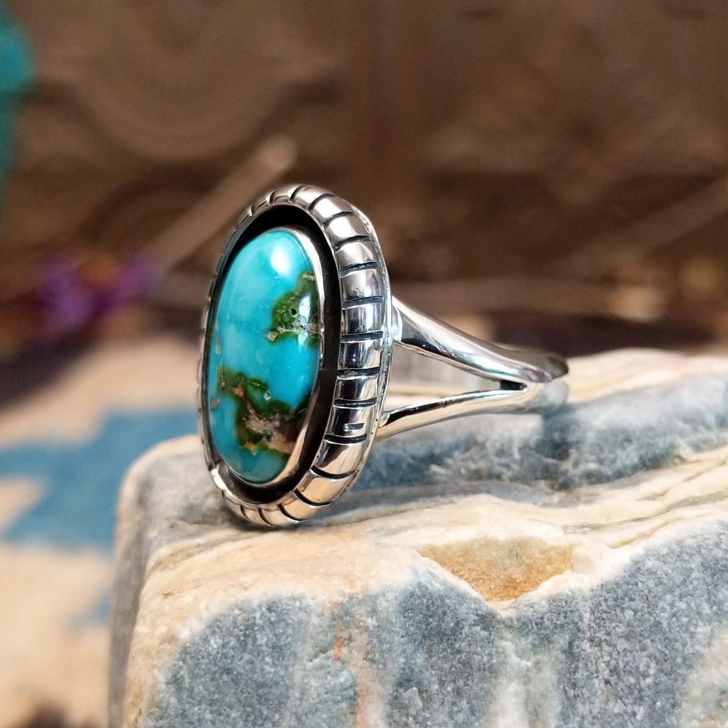 Sterling silver ring with Sonoran gold turquoise set in an oval, shadowbox setting.