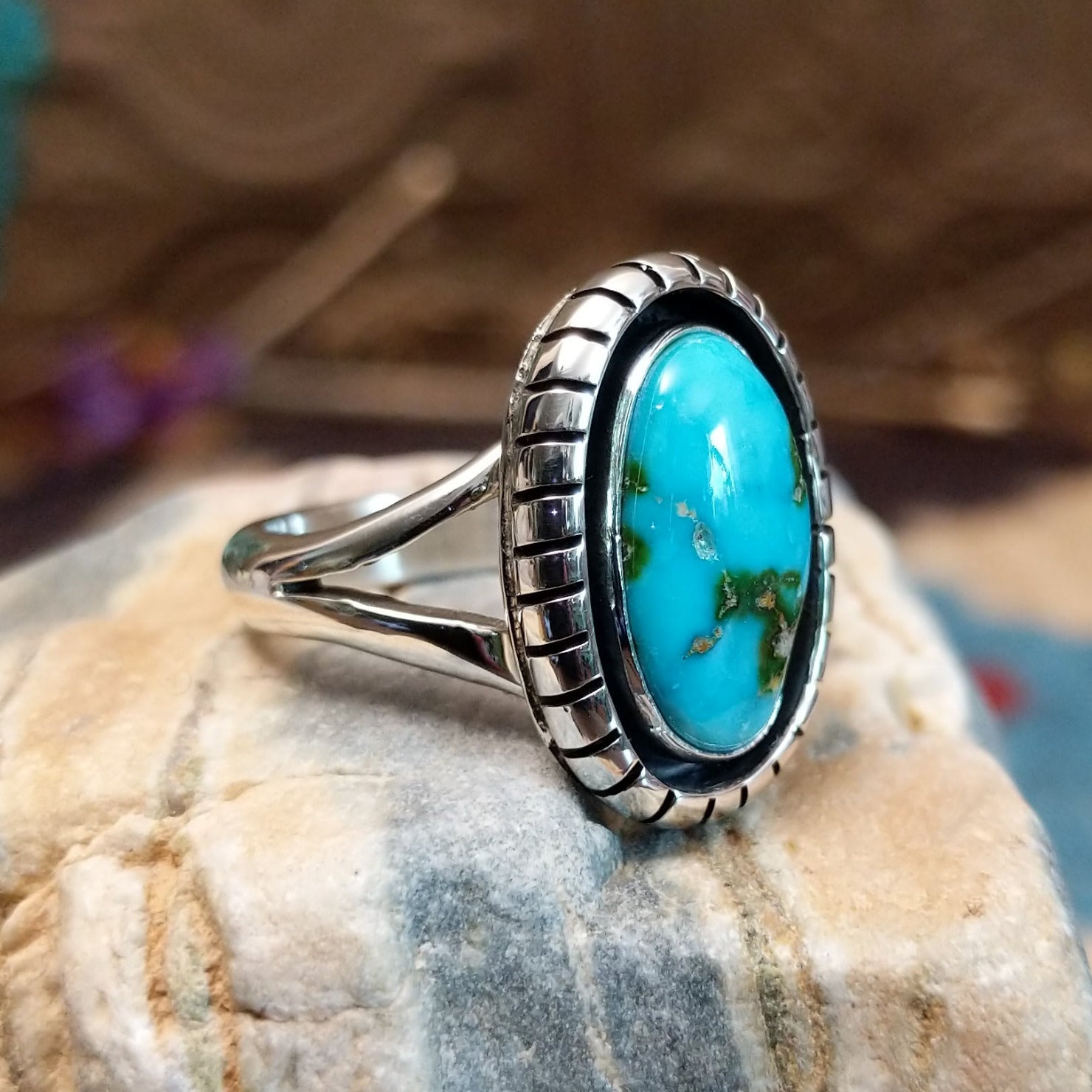Sterling silver ring with Sonoran gold turquoise set in an oval, shadowbox setting.