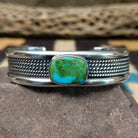 Navajo Sonoran Gold turquoise cuff by H.R.M. with a natural blue-green turquoise stone on a triple-shank sterling silver cuff.