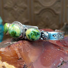 Sterling silver cuff with Sonoran gold turquoise set in oval bezels, framed by twisted rope and dotted accents.